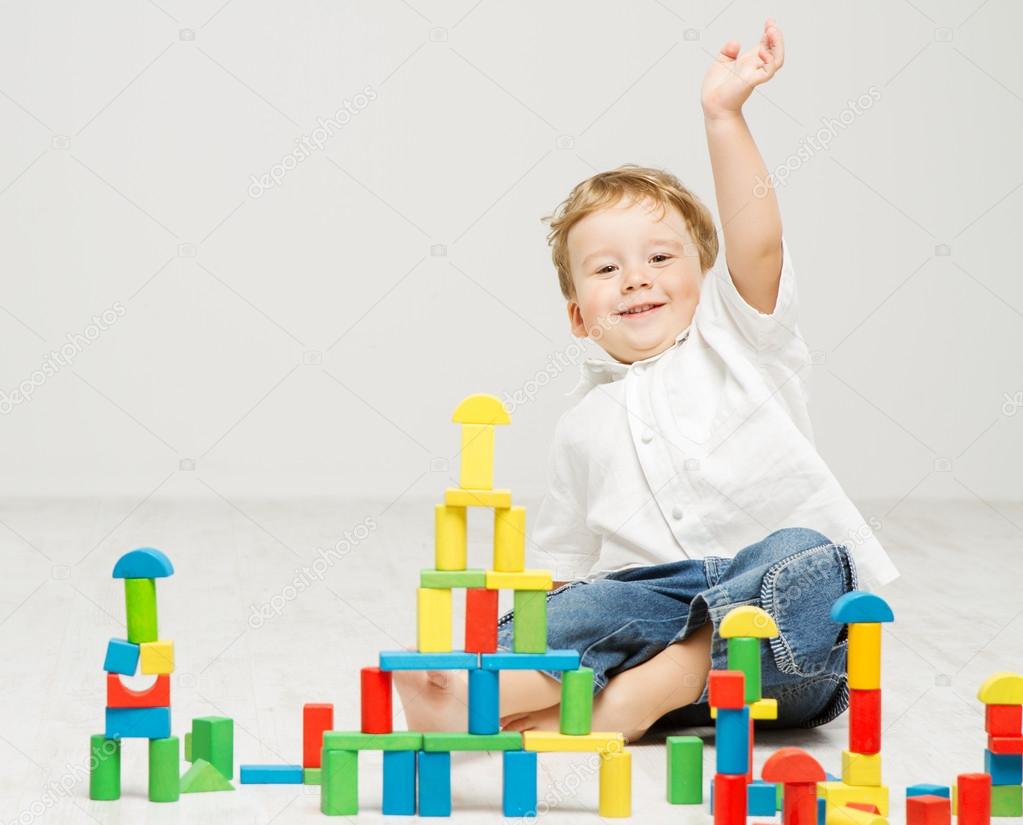 Child playing toys blocks over white