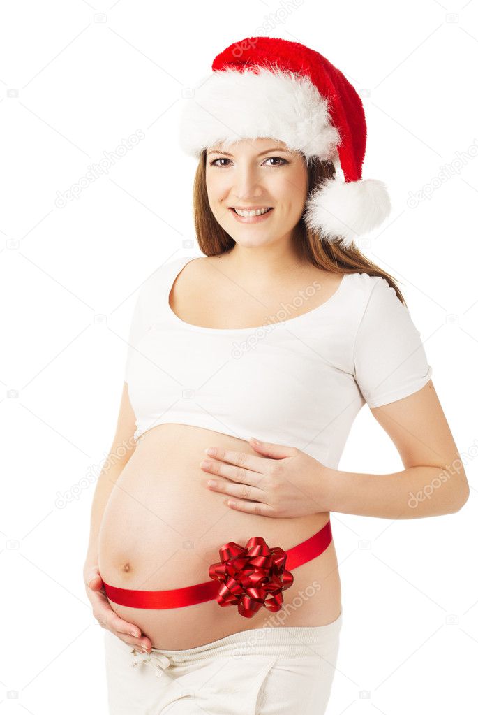 Pregnant woman in Santa hat, belly tied with red ribbon. White i