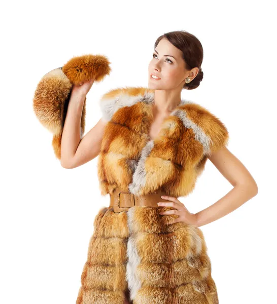 Woman in fur coat, holding fur hat. Isolated white background. — Stock Photo, Image