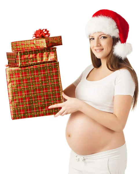 在圣诞老人的帽子，拿着目前的礼品盒中的孕妇。白色的分离 — 图库照片