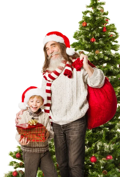 Barn julklappar, jultomten farfar innehav väska i främre fir tree — Stockfoto