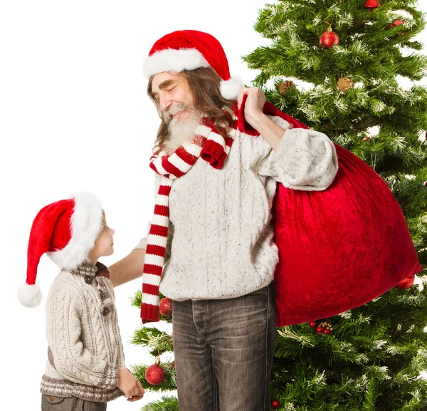 Christmas helper grandson, Santa Claus grandfather with red bag in front fir tree — Stock Photo, Image