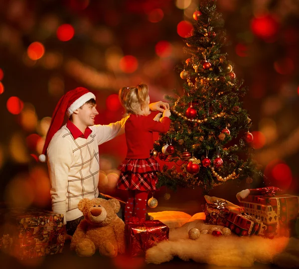 Family decorating Christmas tree. Father and daughter Royalty Free Stock Images