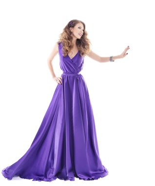 Woman showing advertisement in long purple silk dress over white background