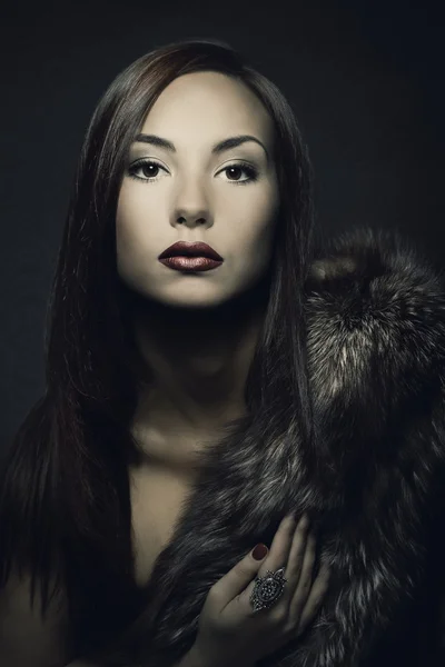 Portrait de beauté femme en manteau de fourrure de luxe. Fond sombre . — Photo