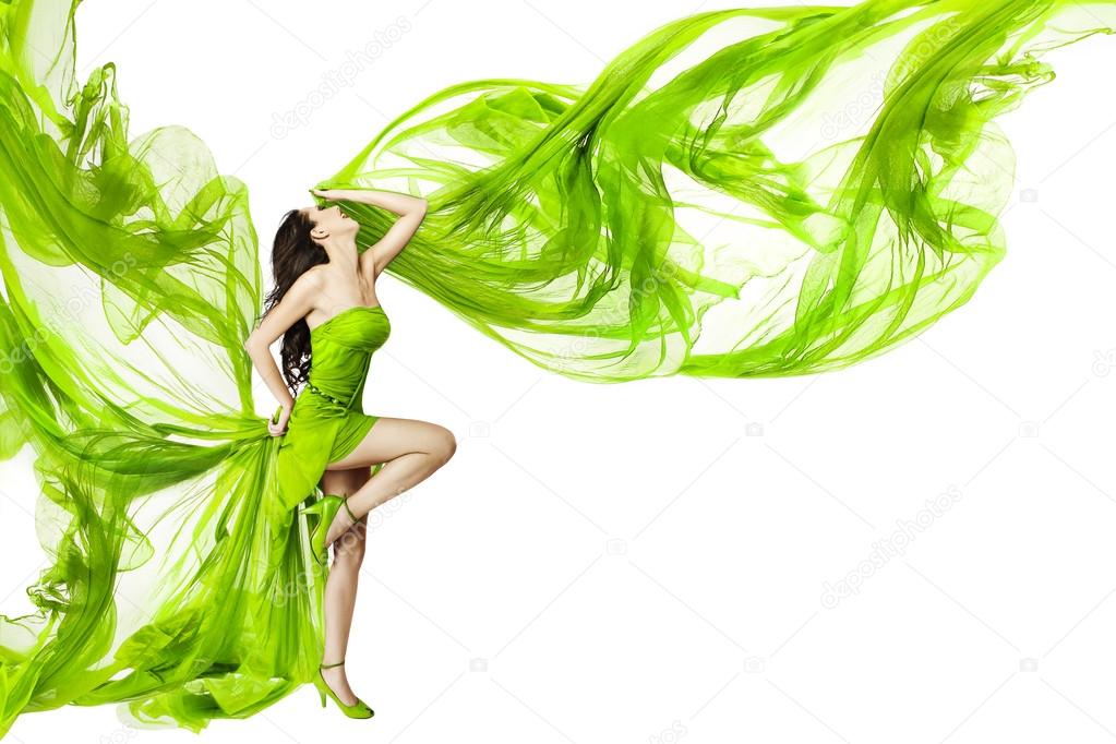 Woman dancing in green dress, fluttering waving fabric, white background