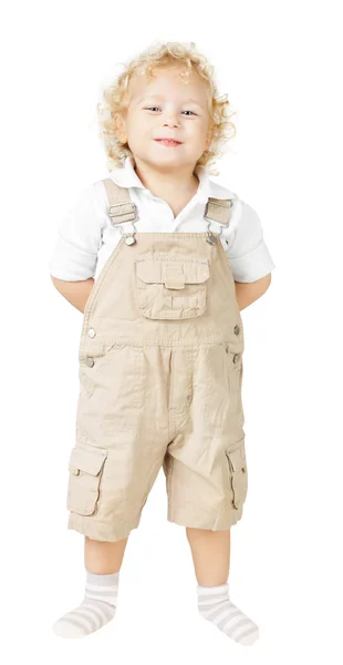 Niño en babero, manos sonrientes detrás de la espalda, fondo blanco — Foto de Stock