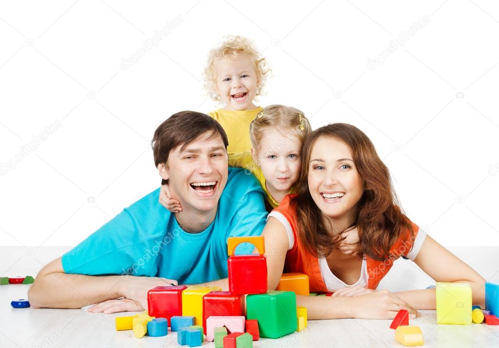 Happy family four persons. Smiling parents kids playing toys blocks