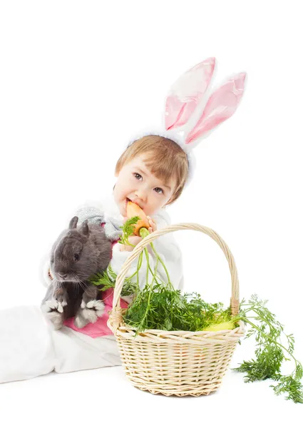 Baby in easter bunny costume eating carrot, kid girl rabbit hare — Stock Photo, Image