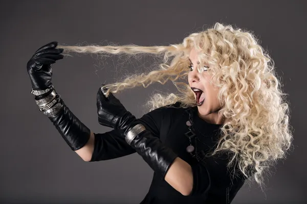 Curly hairstyle blonde in black, woman hairs loss, coloring problem, beautiful girl holding hairs and surprised — Stock Photo, Image