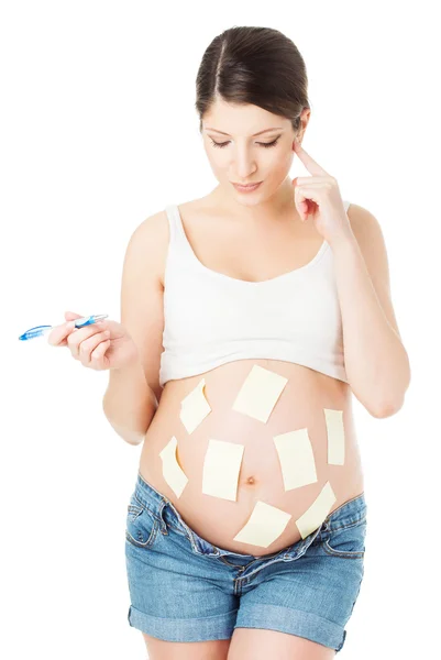 Schwangerschaftsbauch und Aufkleber Notizen, Frau Planung Erinnerung und Aufgabe, Schwangerschaftsideen — Stockfoto