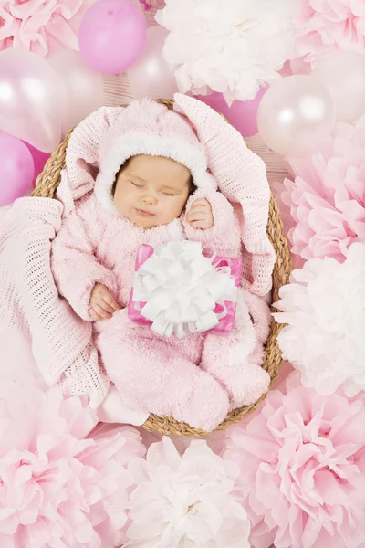 Baby girl with gift sleeping, newborn child birthday present — Stock Photo, Image