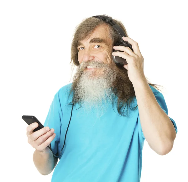 Senior man listening music in phone headphones. Old man with beard, elder isolated white background — Stock Photo, Image