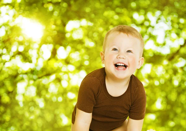 Happy child smiling over green background. Close up baby portrait. — Stock Photo, Image