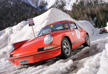 Classic car taking part to the 2014 WinteRace regularity race in Italian Dolomiti clipart