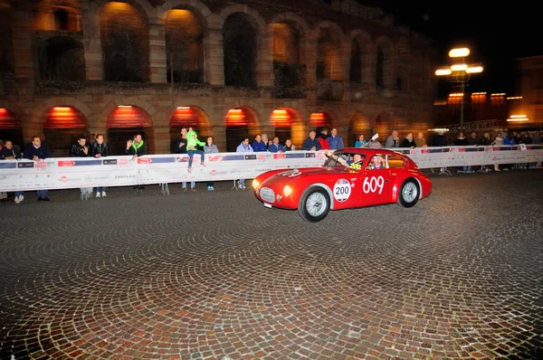 Une Ermini 1100 Berlinetta rouge conduit devant l'Arena di Verona lors de la course de voitures classiques 1000 Miglia le 15 mai 2014 à Vérone. Cette voiture a été construite en 1950 Photos De Stock Libres De Droits