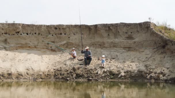 Boy fishing with his grandparent — Stock Video