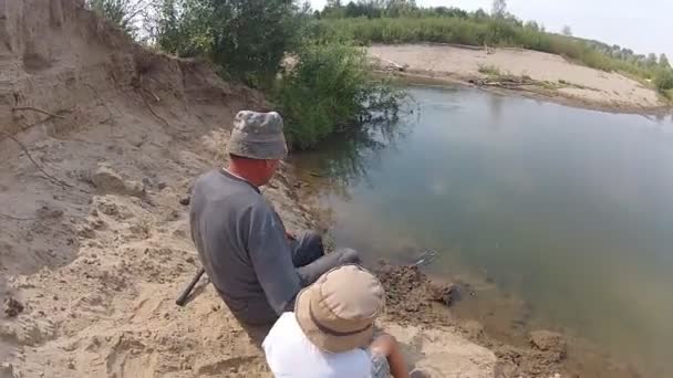 Boy fishing with his grandparent — Stock Video