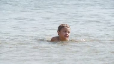 Happy boy enjoying the sea