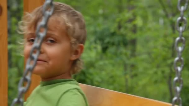 The boy on a swing closeup — Stock Video