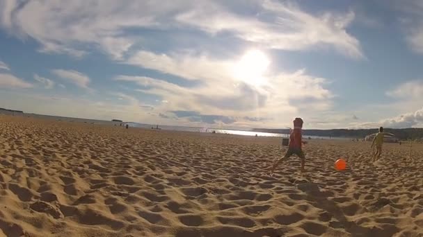 Irmãos brincam com uma bola de praia ao ar livre — Vídeo de Stock