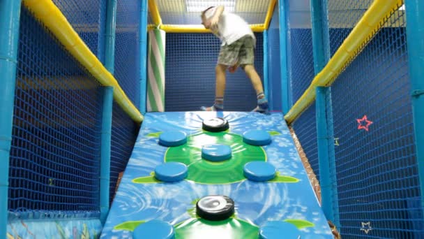 Happy boys playing on an attraction playground — Stock Video