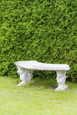 An ornate semi circular stone bench for a very grand garden.