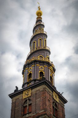 COPENHAGEN, DENMARK - SEPTEMBER 03, 2022: The Church of Our Saviour is a baroque, 17th-century place of worship with a carillon & steps around the outside of the spire.