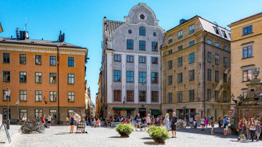 STOCKHOLM, SWEDEN - JULY 31, 2022: This cobblestone plaza dating back to the Middle Ages has colorful historic buildings