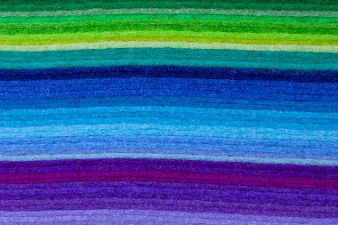 abstract background: close up of pile of multicolor felt sheets
