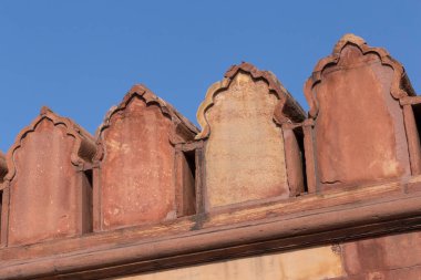 merlons on wall of Jama Masjid mosque in Delhi against blue sky