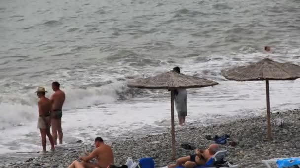 People sunbathing on a beach — Stock Video