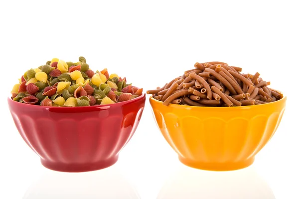 Wholemeal pasta in colorful bowls — Stock Photo, Image