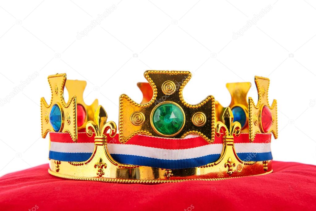 Golden crown on velvet pillow with Dutch flag