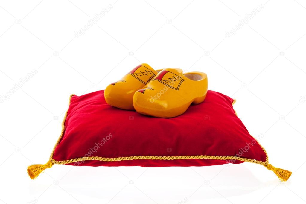 Royal red velvet pillow with wooden clogs