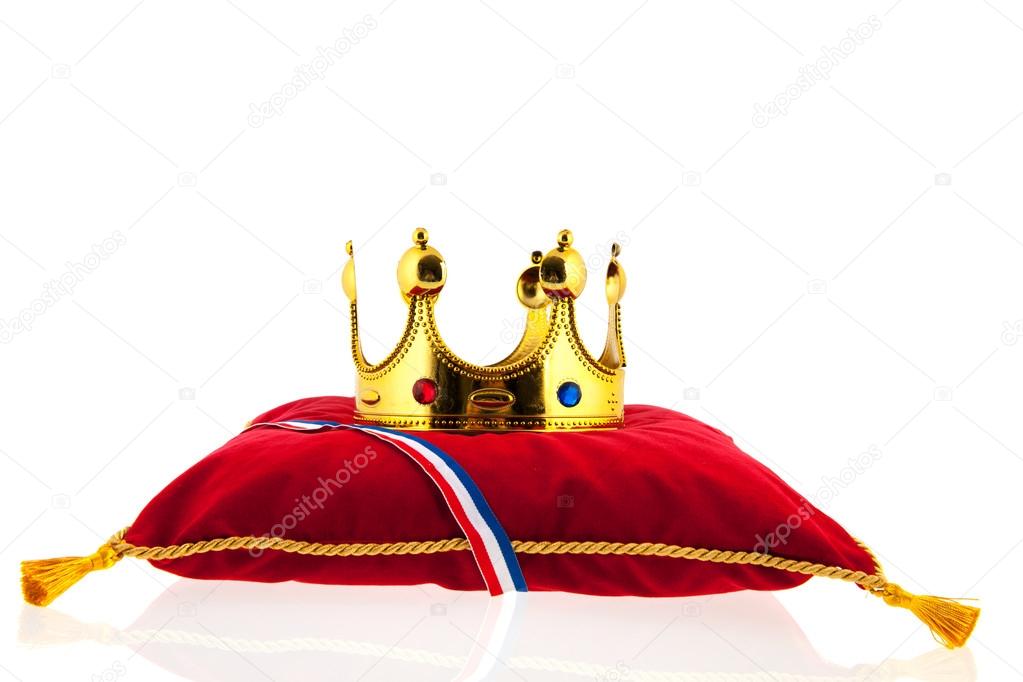 Golden crown on velvet pillow with Dutch flag