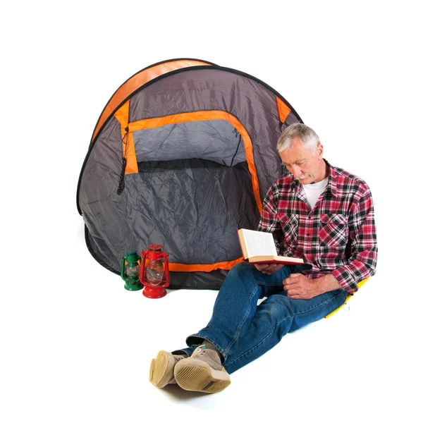 Senior man by tent — Stockfoto
