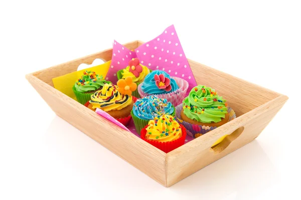 Colorful cupcakes on wooden tray — Stock Photo, Image