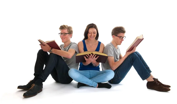 Adult male twins and young girl reading books — Stock Photo, Image