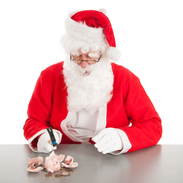 圣诞老人打破穷人存钱罐 — 图库照片