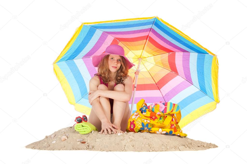 Sunbathing at the beach with colorful parasol