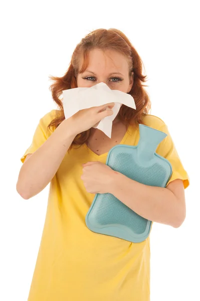 Red haired woman blowing nose with hot water-bottle — Stock Photo, Image