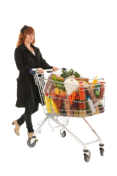 Mujer con carrito de compras lleno de productos lácteos — Foto de Stock