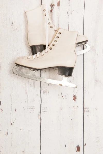 Hanging ice skates on wooden wall — Stock Photo, Image