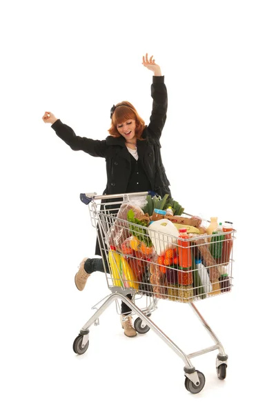 Mulher feliz com carrinho de compras completo de laticínios — Fotografia de Stock