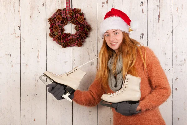 Woman in winter with ice skates and hat Santa Claus — Stock Photo, Image