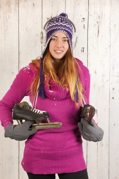 Woman in winter with ice skates — Stock Photo, Image