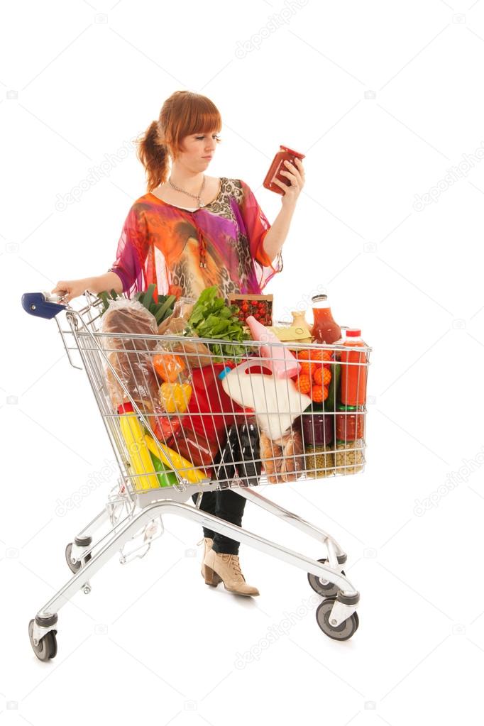 Woman with Shopping cart reading label