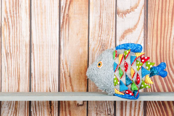 Stuffed funny fish on wooden background — Stock Photo, Image