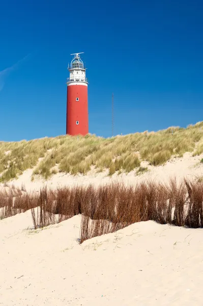 Red lighthouse at the coast — Stock Photo, Image